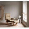 Stressless Mayfair Medium Recliner and Footstool in Paloma Leather with a Classic Beech Wood Base. This ergonomic lounge chai