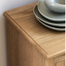 Gallery Direct Malvern 1 Door 4 Drawer Sideboard showcasing top detail and edge with set of plates on top