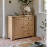 Gallery Direct Malvern 1 Door 4 Drawer Sideboard side view in kitchen against wall with clay stone floor tiles and flowers