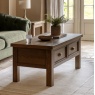 Gallery Direct Hardwick 2 Drawer Coffee Table on a plush cream rug in front of sofa in a lounge