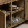 Gallery Direct Hardwick 3 Door 3 Drawer Sideboard with cupboard open with crockery and plates stored inside