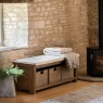 Gallery Direct Hardwick Hall Bench in cottage lounge by stone window next to wood burner with a jumper on top