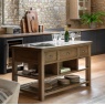 Gallery Direct Hardwick Kitchen Island in kitchen with wooden floor and stone cottage walls with bottle of champagne on top