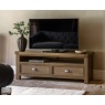 Gallery Direct Hardwick Media Unit with tv on top and vase on carpet in lounge in front of blue sofa