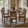 Gallery Direct Hardwick Round Extending Dining Table set image in dining room on cream rug in front of bifold windows
