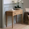 Gallery Direct Malvern 1 Drawer Console Table with vase and flowers on top against wall on warm rug