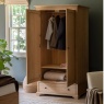Gallery Direct Malvern 2 Door 1 Drawer Wardrobe in bedroom with wood floor with doors open and hanging clothes inside robe