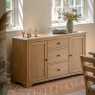 Gallery Direct Malvern 2 Door 3 Drawer Sideboard on tiled herringbone floor with glasses on top and vase