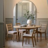 Gallery Direct Malvern Round Extending Dining Table in dining room with plated and glasses for dining