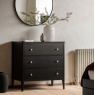 Gallery Direct Acton 3 Drawer Chest Black with white vase on top and round mirror on wall