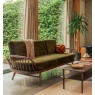 Ercol 7355 Studio Couch in Dark Wood Finish with Green Velvet Upholstery in a modern living room setting - Brentham Furniture