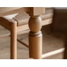 Turned leg detail of the Eton round extending dining table in natural wood