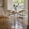 White round extending dining table by Gallery Direct shown extended in a dining room setting