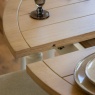 Gallery Direct Eton white round extending dining table showing oak top and extension leaf detail