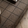 Textured concrete tile surface detail on the Gallery Direct Novara coffee table in charcoal brown