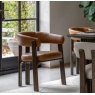 Gallery Direct Onda dining chair in brown leather styled at a modern dining table