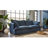 Slouchy Tetrad Ava Grand Sofa with washable denim blue loose covers in a bright, airy living room with indoor plants - Brenth