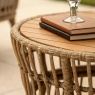 Top-down view of the Agadir round coffee table highlighting the natural acacia wood grain top and woven base.