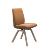 Stressless Laurel D200 low back dining chair Batick Caramel leather dining chair with wooden legs – angled view